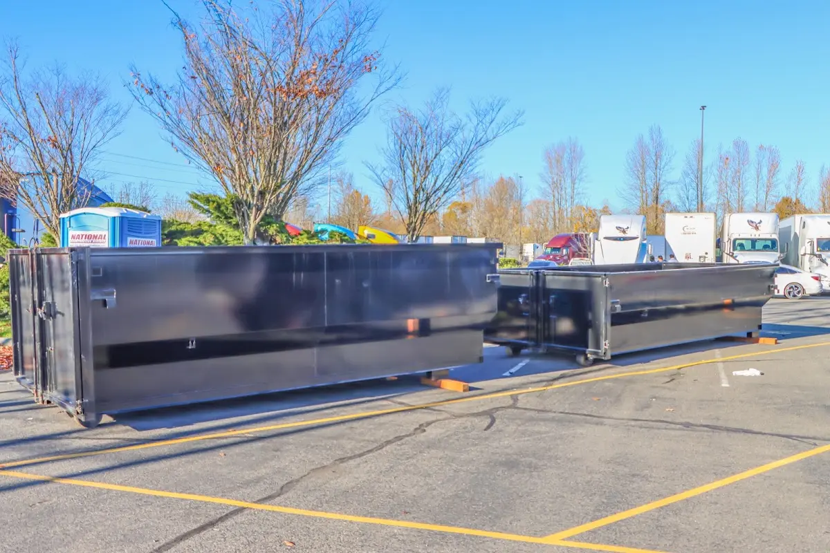 Professional dumpster rental service with roll-off container on residential driveway in San Dimas